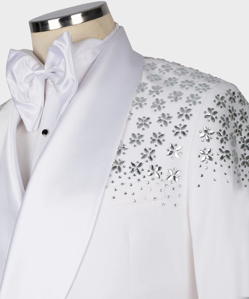 White tuxedo with floral embellishments on a mannequin against a white background