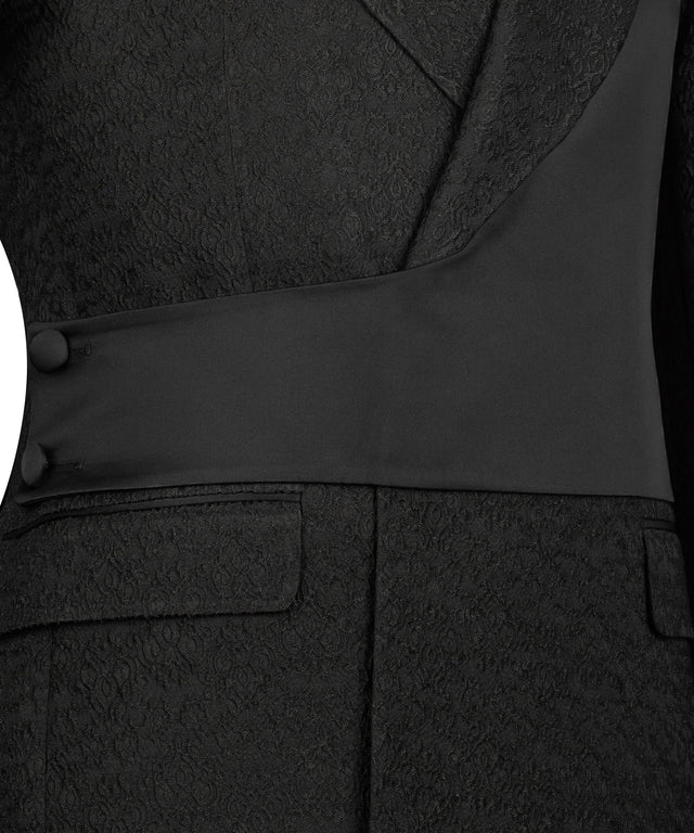 KOSS ATELIER black double-breasted tuxedo close up showing textured jacquard fabric shawl lapel waist sash and flap pockets