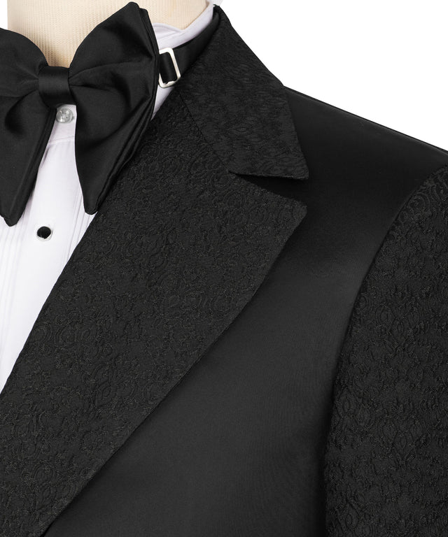 KOSS ATELIER black double-breasted tuxedo close up showing textured jacquard lapel satin panel white dress shirt and black bow tie