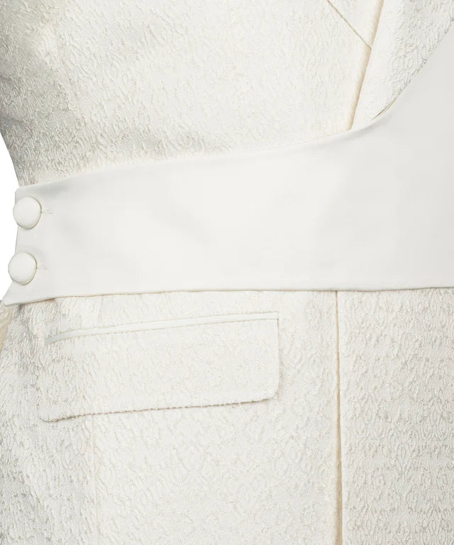 Close up of KOSS ATELIER cream double breasted tuxedo with textured fabric sash covered buttons and flap pocket