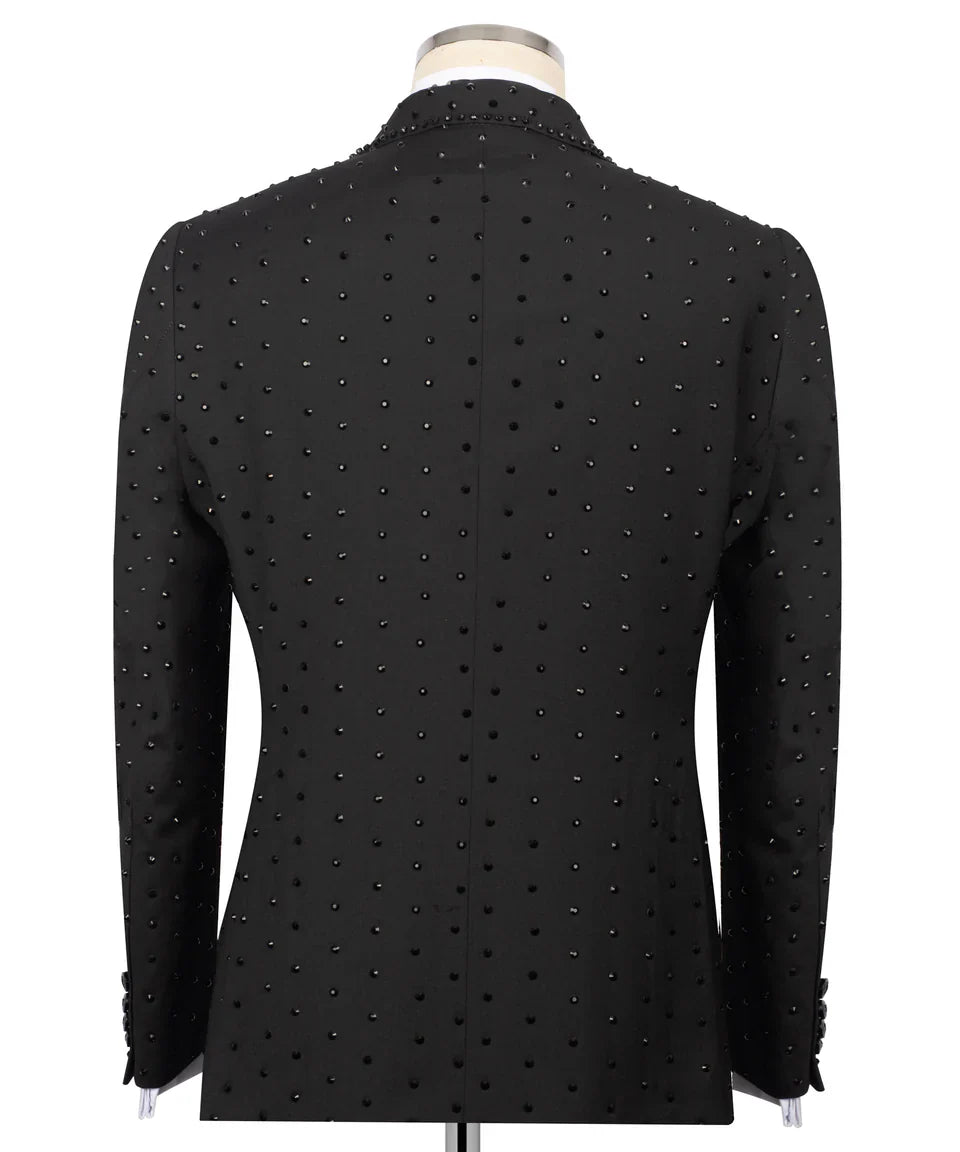 Back view of KOSS ATELIER handmade black studded tuxedo jacket on mannequin with allover black studs