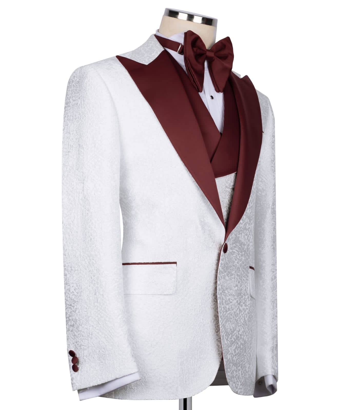 KOSS ATELIER white textured tuxedo for men with burgundy shawl lapel, vest, and bow tie