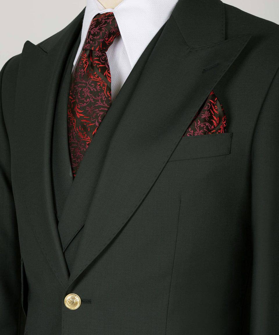 KOSS ATELIER deep green three piece suit with peak lapels gold button red patterned tie and pocket square