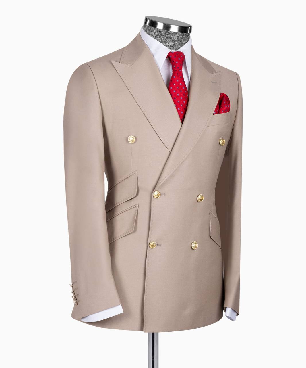 KOSS ATELIER beige double breasted men’s three-piece suit displayed on mannequin with red tie pocket square and gold buttons