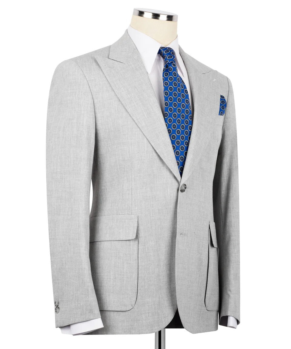 Gray suit jacket with a blue patterned tie and pocket square on a mannequin against a white background