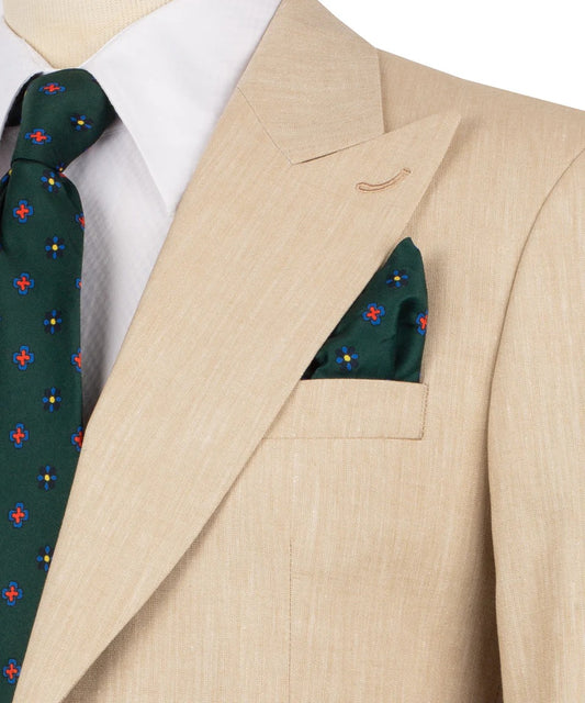 Beige suit jacket with a green tie and pocket square featuring red and blue patterns.