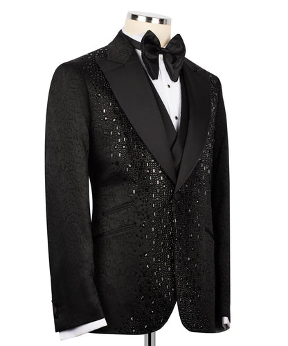 Black sequin tuxedo jacket on a mannequin with a white shirt and black bow tie.
