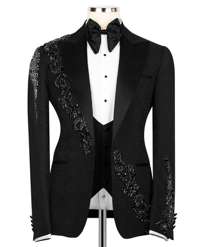 Black tuxedo with decorative lapels on a mannequin against a white background