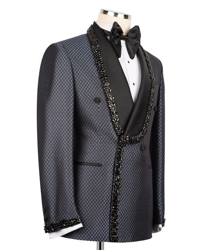Black patterned tuxedo with decorative lapels on a mannequin against a white background