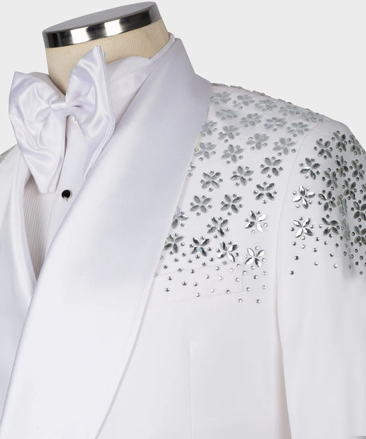 White tuxedo with floral embellishments on a mannequin against a white background