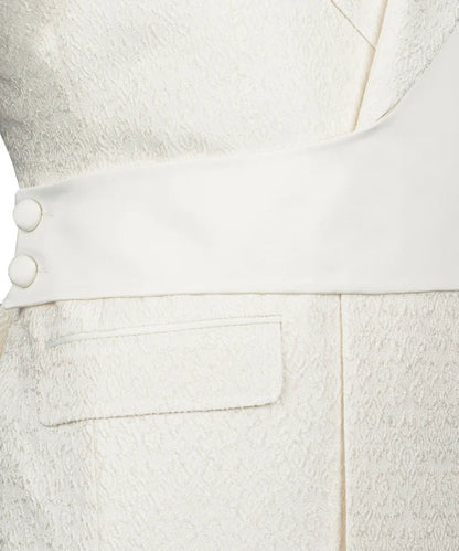 Close up of KOSS ATELIER cream double breasted tuxedo with textured fabric sash covered buttons and flap pocket