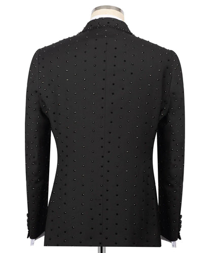 Back view of KOSS ATELIER handmade black studded tuxedo jacket on mannequin with allover black studs