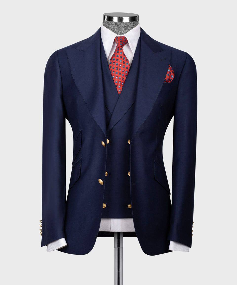 KOSS ATELIER men's navy three-piece suit on mannequin with double-breasted vest gold buttons and red tie