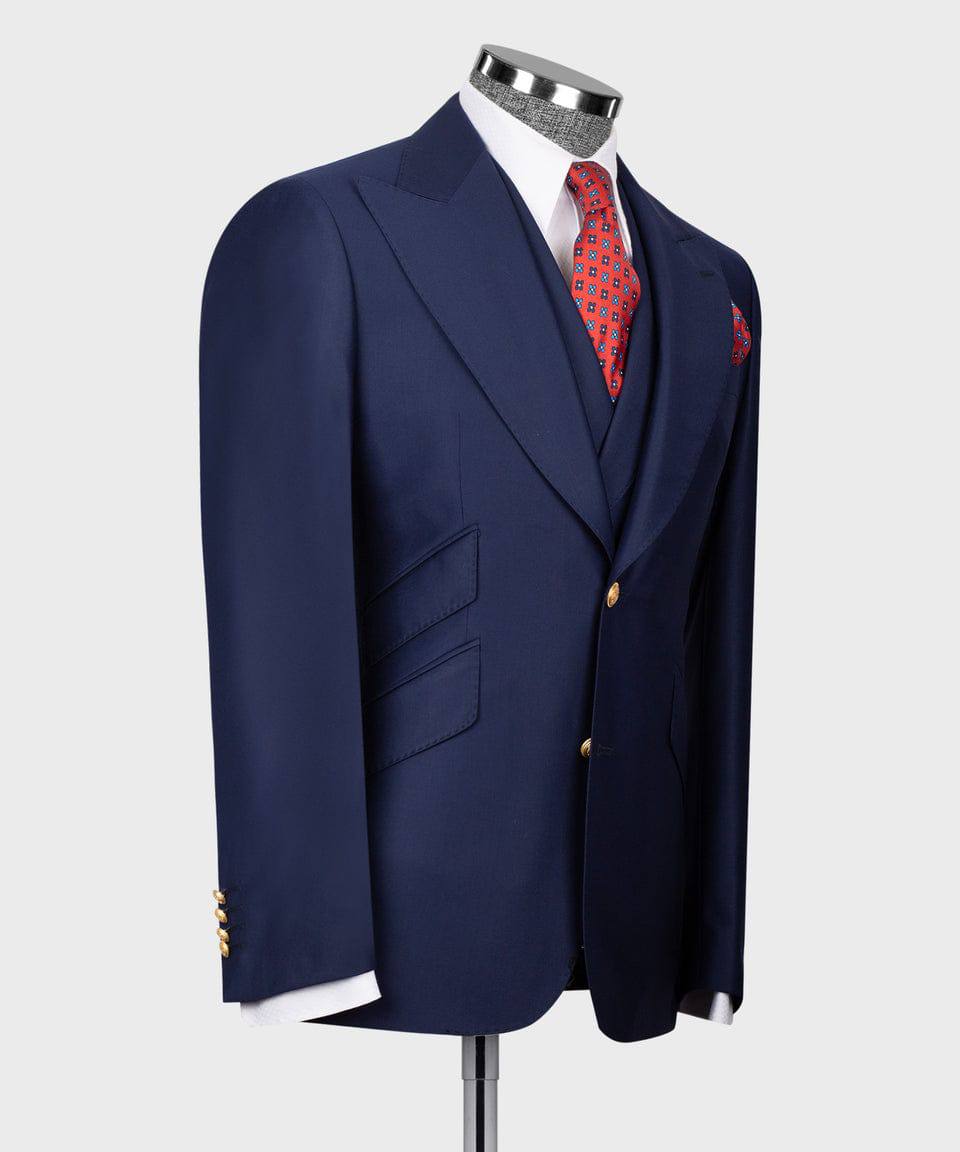 KOSS ATELIER men's navy three-piece suit on mannequin with red patterned tie and pocket square