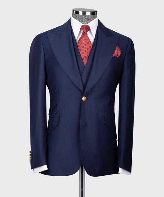 KOSS ATELIER men's navy three-piece suit on mannequin with tailored jacket vest red patterned tie and pocket square