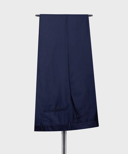 KOSS ATELIER men's navy three-piece suit trousers draped on hanger showing back pocket and hem