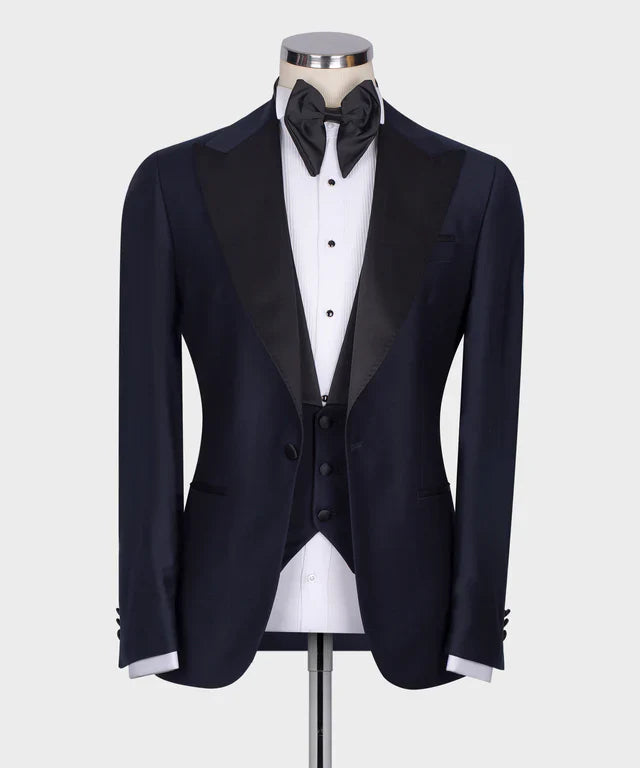 KOSS ATELIER Classic Dark Blue Tuxedo with satin peak lapel vest and black bow tie on mannequin