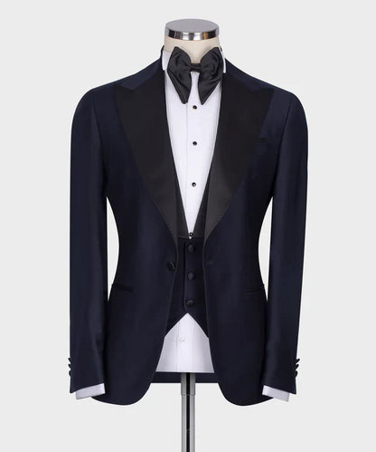 KOSS ATELIER Classic Dark Blue Tuxedo with satin peak lapel vest and black bow tie on mannequin