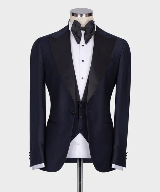 KOSS ATELIER Classic Dark Blue Tuxedo with satin peak lapel vest and black bow tie on mannequin