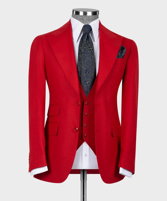 KOSS ATELIER tailored crimson red 3-piece suit for men on mannequin with white shirt and navy patterned tie