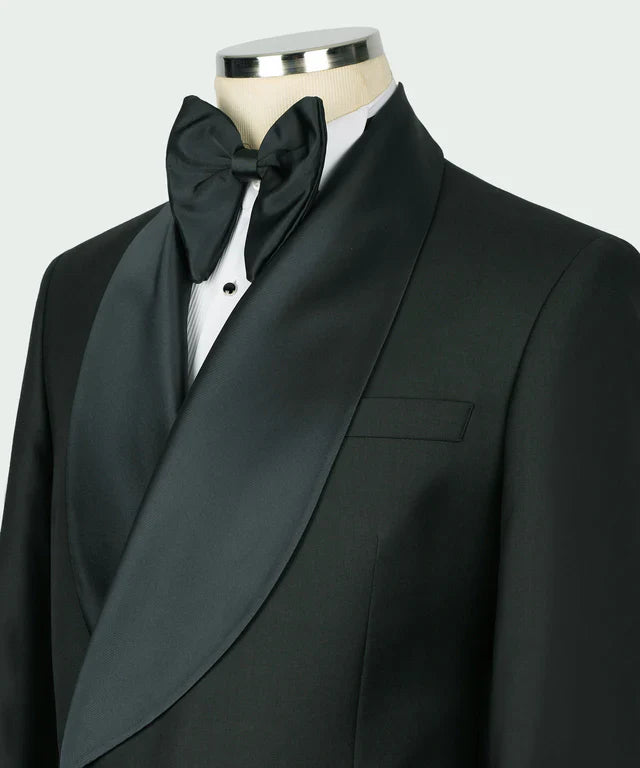 KOSS ATELIER green double breasted tuxedo with satin shawl lapel and bow tie on mannequin