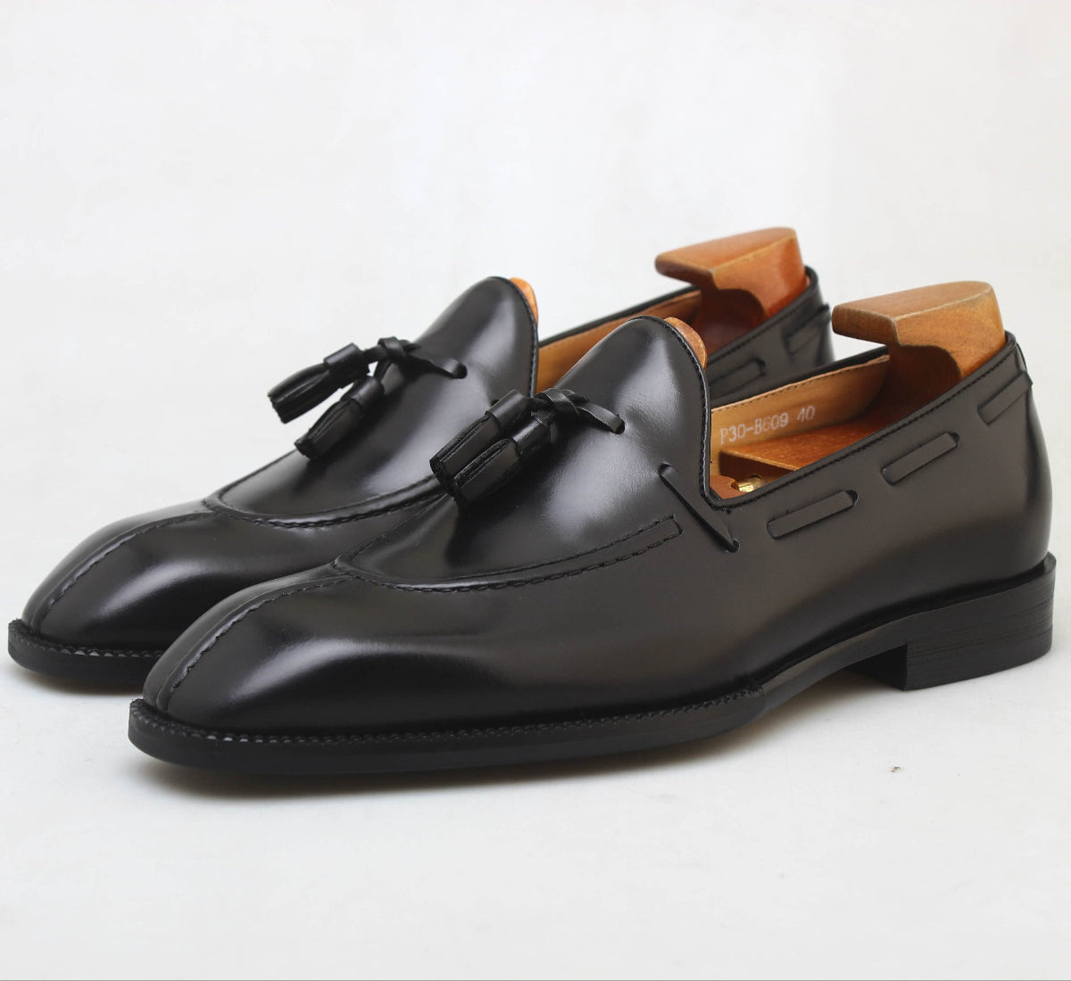 KOSS ATELIER black leather tassel loafers with a sleek design for formal occasions