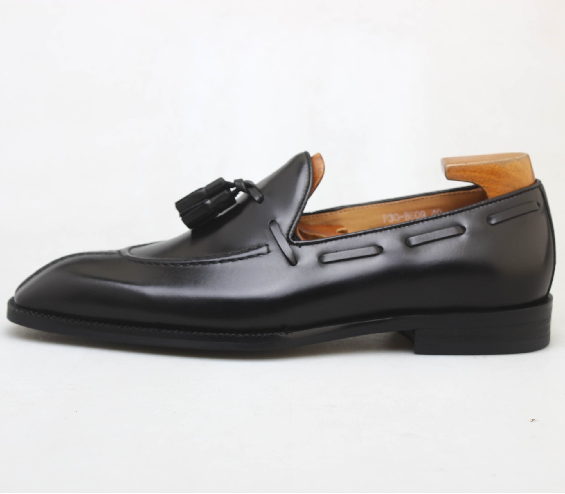 KOSS ATELIER black leather tassel loafers with a sleek design and comfortable fit