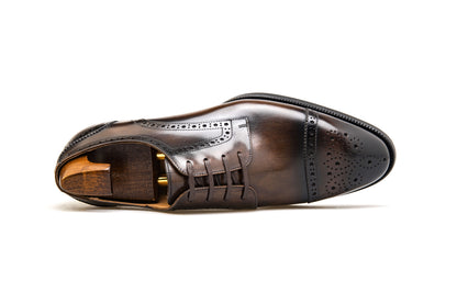 KOSS ATELIER brown cap-toe oxford shoes featuring intricate brogue detailing and a sleek design