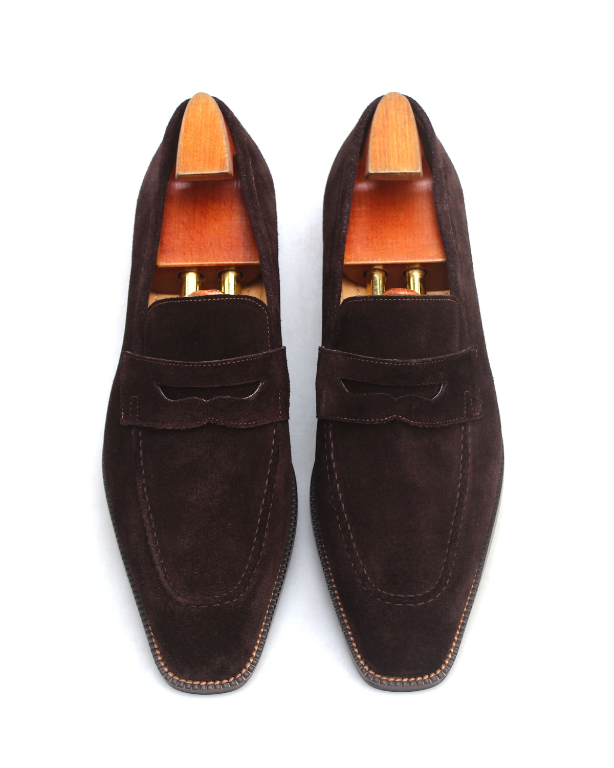 Brown suede shoes with wood detail featuring a stylish bow design and elegant finish