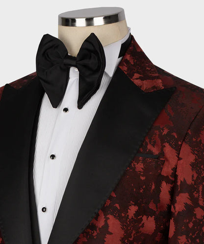 KOSS ATELIER burgundy tuxedo for men with black satin peak lapel patterned jacket white pleated shirt and black bow tie