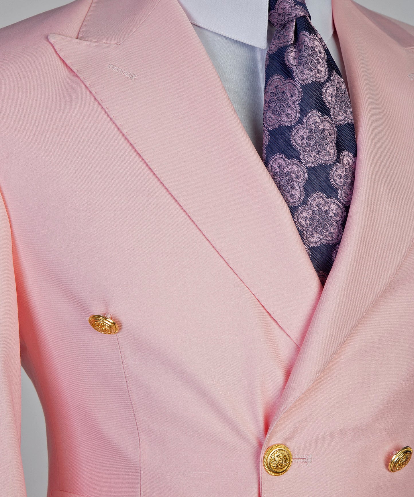 Light pink Double Breasted blazer with gold buttons and a patterned tie for a stylish look