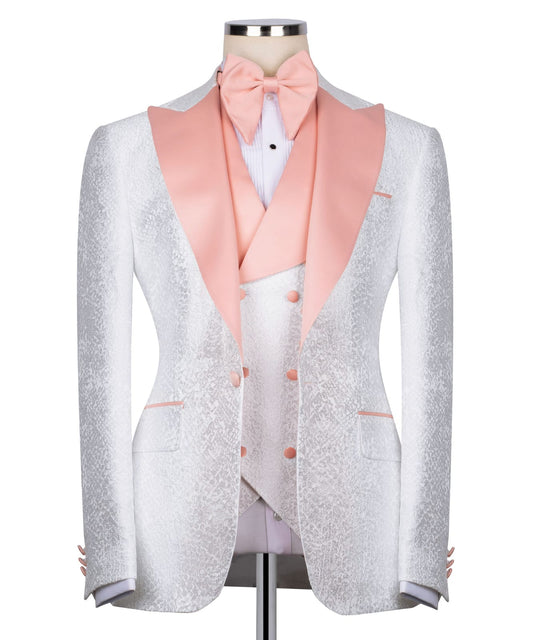 KOSS ATELIER white textured tuxedo for men with blush pink satin shawl lapel vest and bow tie on mannequin