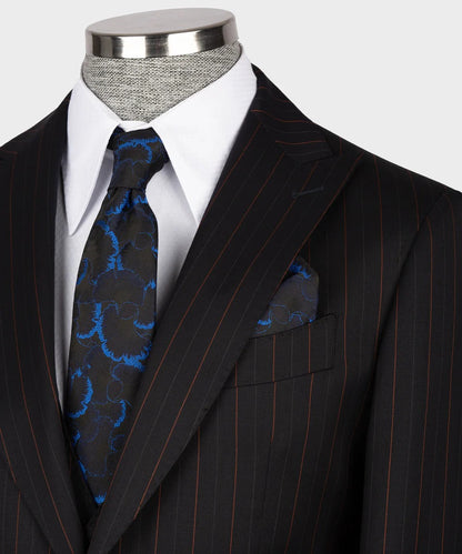 black and red pinstripe suit by KOSS ATELIER on mannequin with white dress shirt blue patterned tie and pocket square