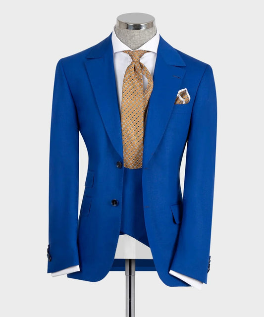 KOSS ATELIER regal blue 3-piece suit for men on mannequin with white shirt and patterned gold tie