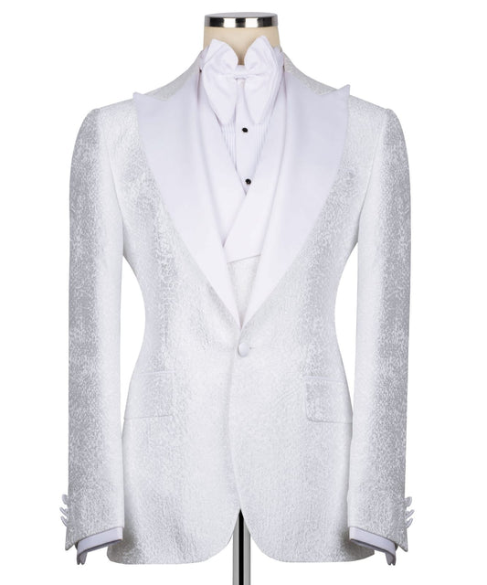 KOSS ATELIER white textured tuxedo for men single button jacket with shawl lapel matching vest and bow tie on mannequin