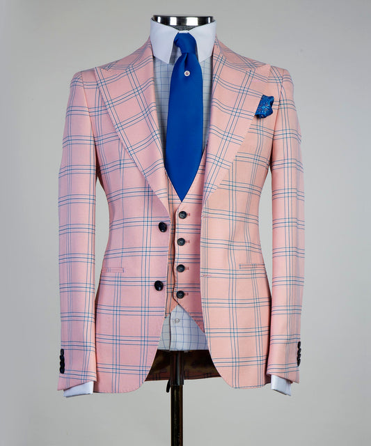 Stylish pink plaid suit outfit with a tailored fit and contrasting blue tie for a fashionable look