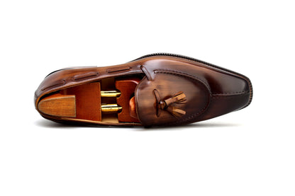Premium brown loafer shoes with elegant design and wooden shoe trees for style and care