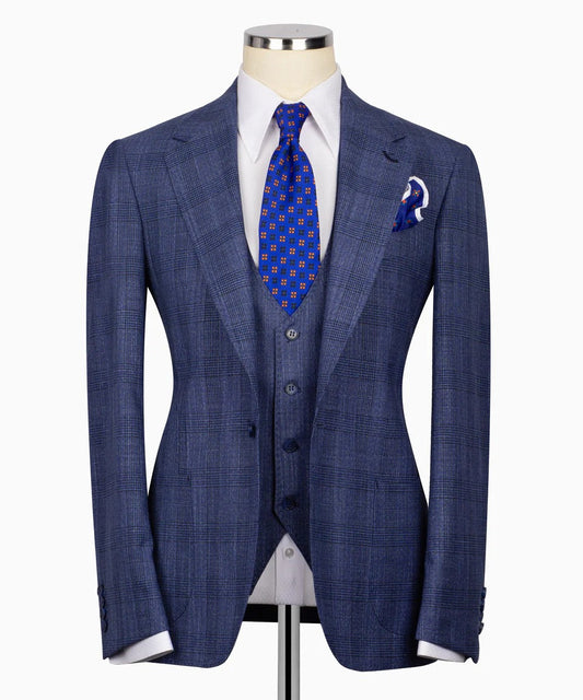 Mannequin wearing blue glen plaid three piece suit with matching vest white dress shirt patterned blue tie and pocket square