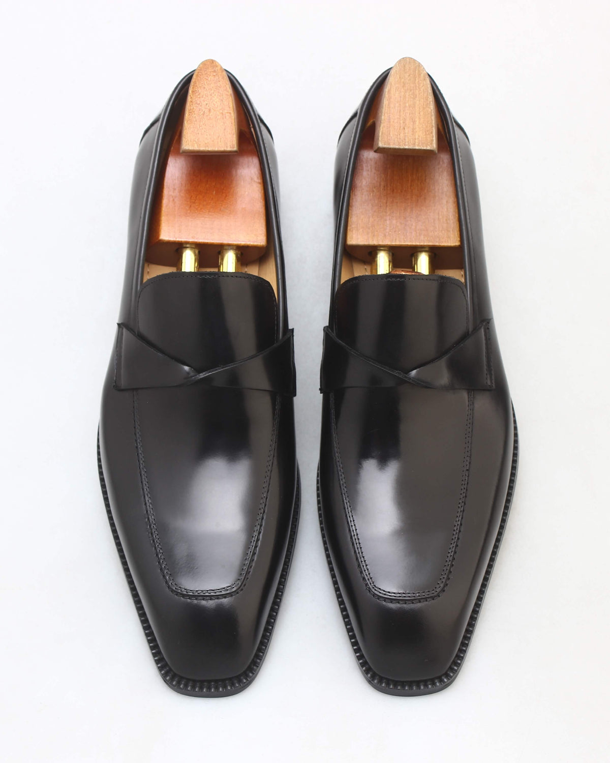 Sleek black apron loafers with a polished finish and stylish design for formal occasions