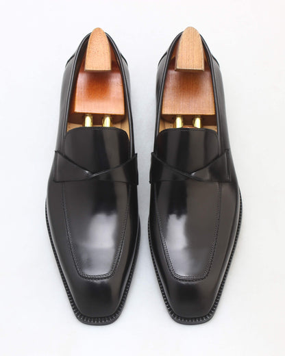 Sleek black apron loafers with a polished finish and stylish design for formal occasions