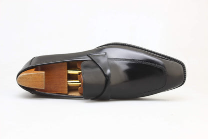 Sleek black apron loafers by KOSS ATELIER with polished leather finish and elegant design